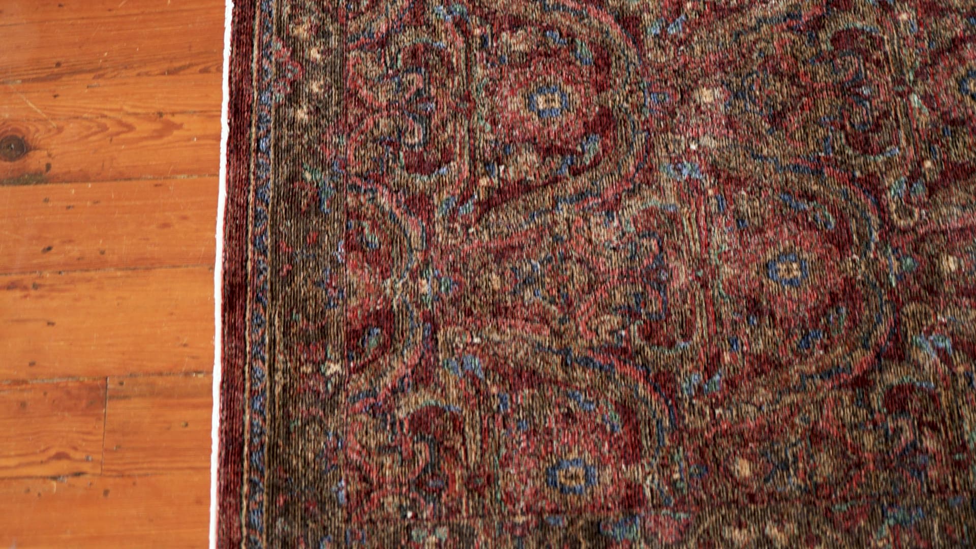 Monarch Red/Multi rug, filmed on a wood floor
