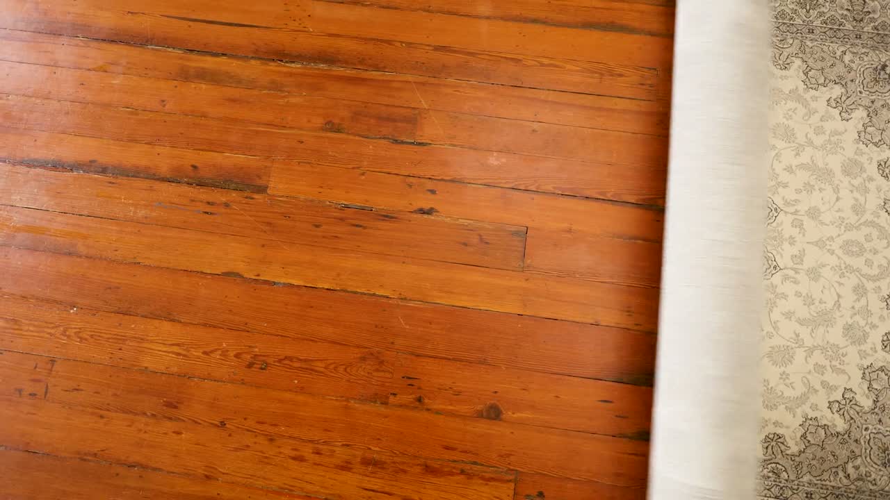 Ember Cream/Grey rug, filmed on a wood floor